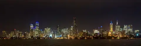 The Melbourne skyline lit up at night across the Yarra River