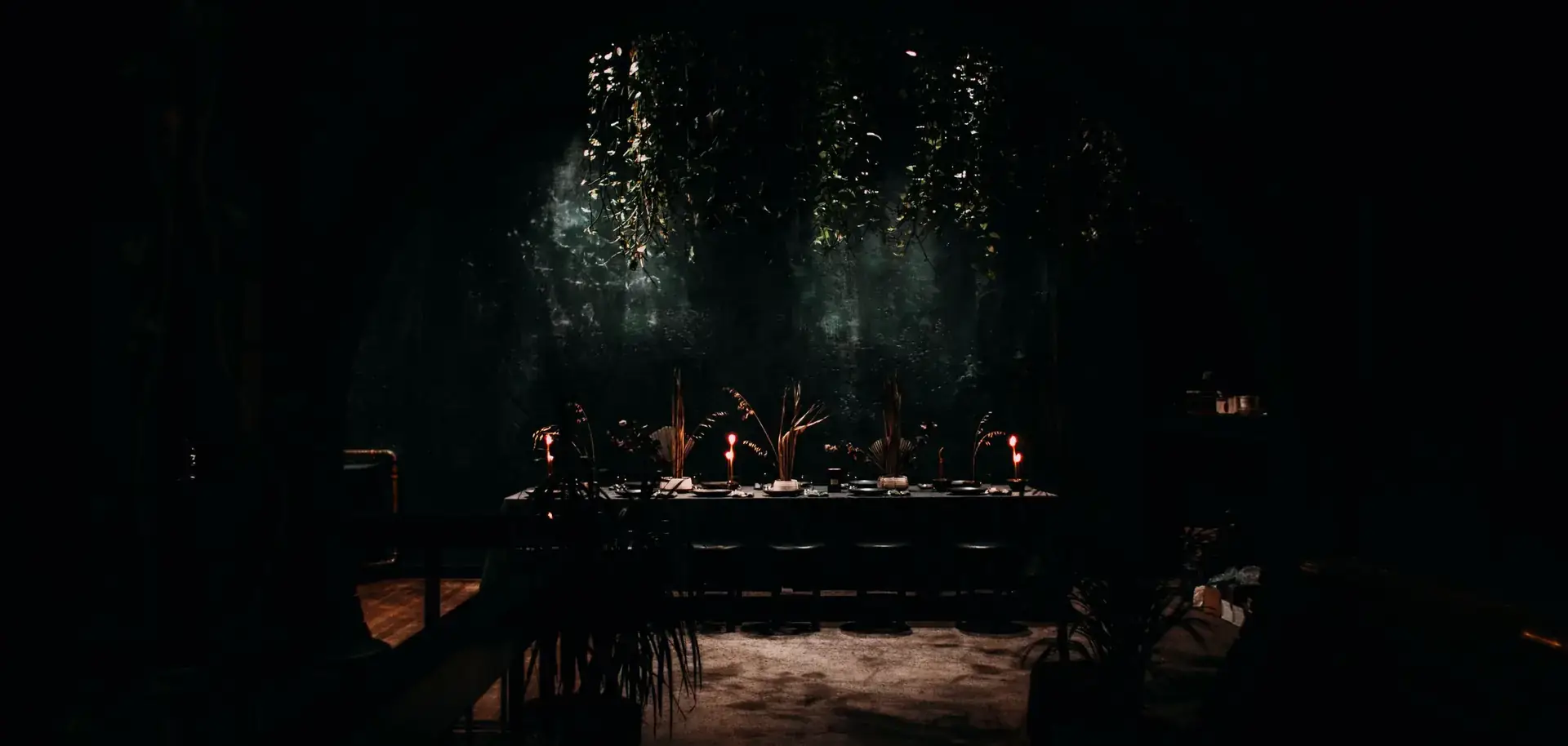 A candlelit table in a dark, quiet bar