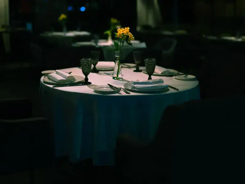 A table set for dinner in a dimly lit restaurant