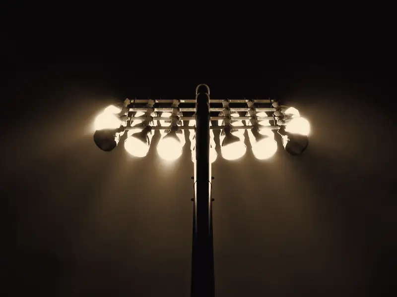 Stadium floodlights glowing against a night sky