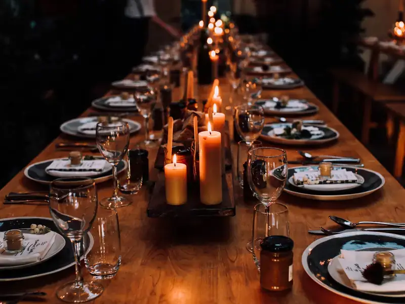 A long banquet table set with candles and plates